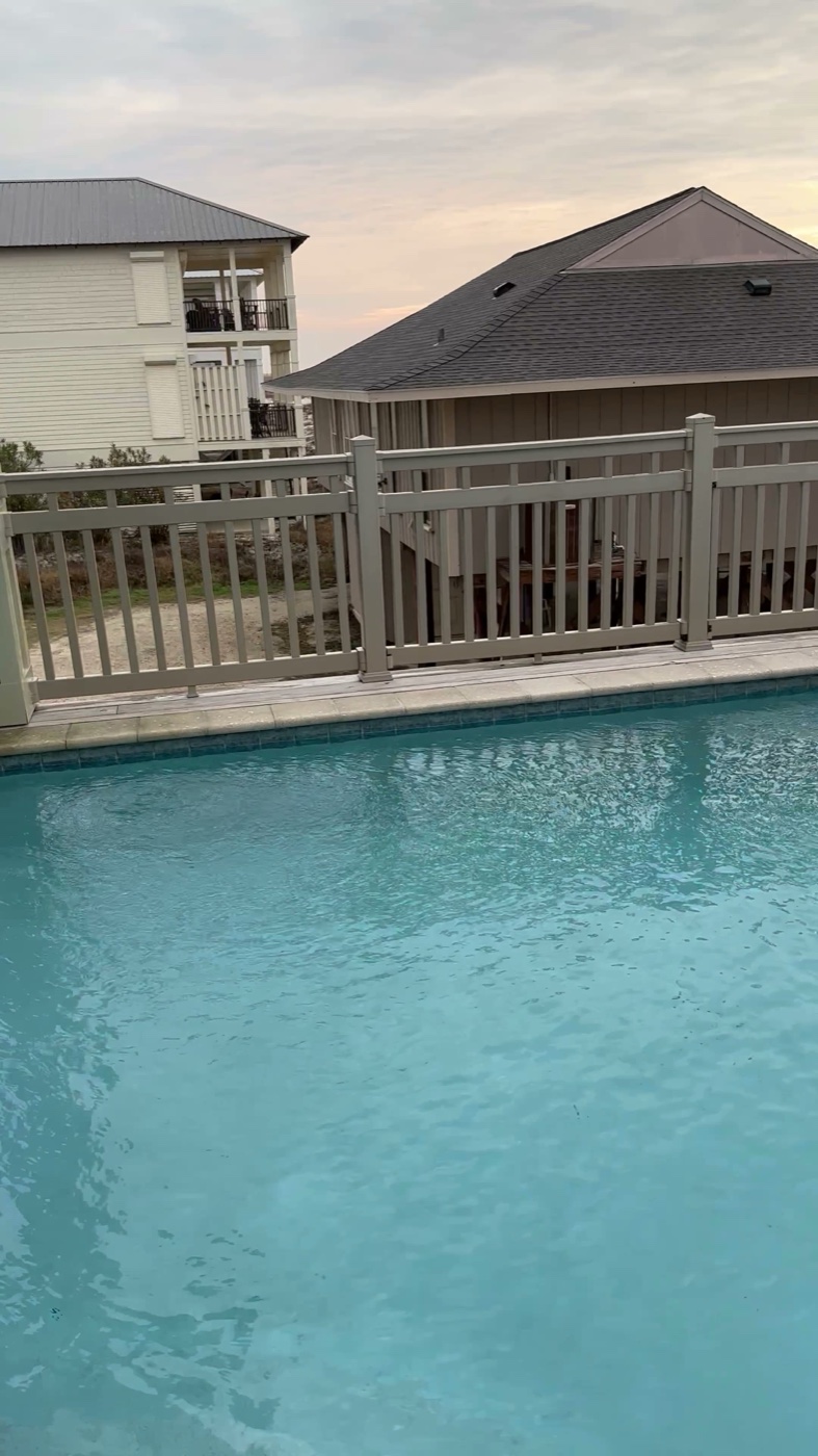A heated private pool at dusk on the Fort Morgan beachfront