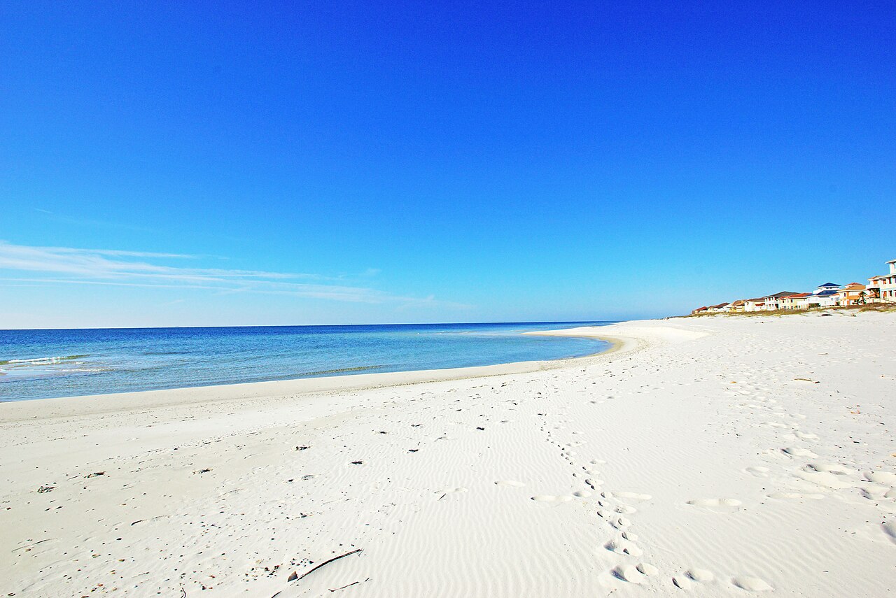 Sugar-white quartz sand and clear emerald Gulf water along the Gulf Shores beach